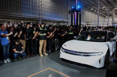 Arizona governor Doug Ducey rides in the passenger seat as CEO Peter Rawlinson drives a Lucid Air car off the line at the Lucid Motors plant in Casa Grande in September 2021. Reuters