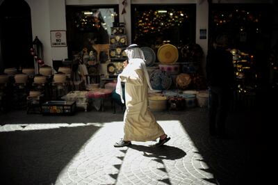 A man walks in front of a souvenir shop at a souq in Manama, Bahrain. Reuters