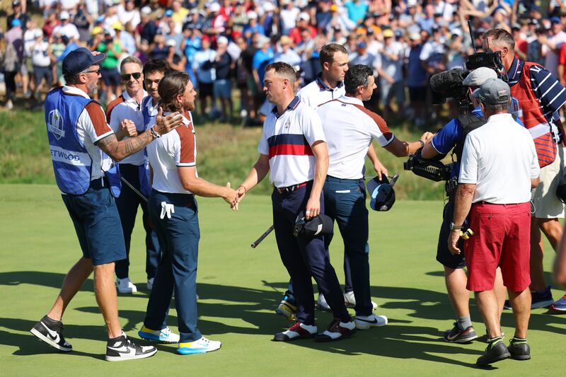 Rory McIlroy and Tommy Fleetwood of Team Europe shake hands with Justin Thomas and Jordan Spieth of Team United States. Getty