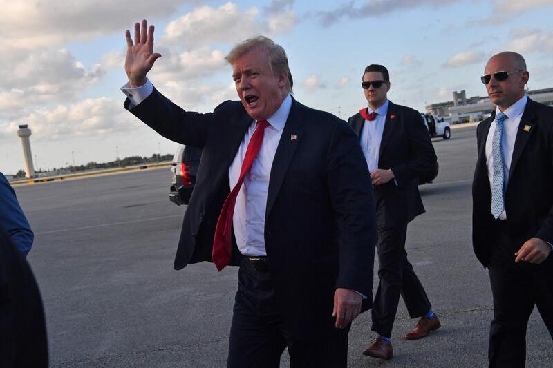 Donald Trump waves upon arrival at Palm Beach International airport, Florida on April 18, 2019. AFP