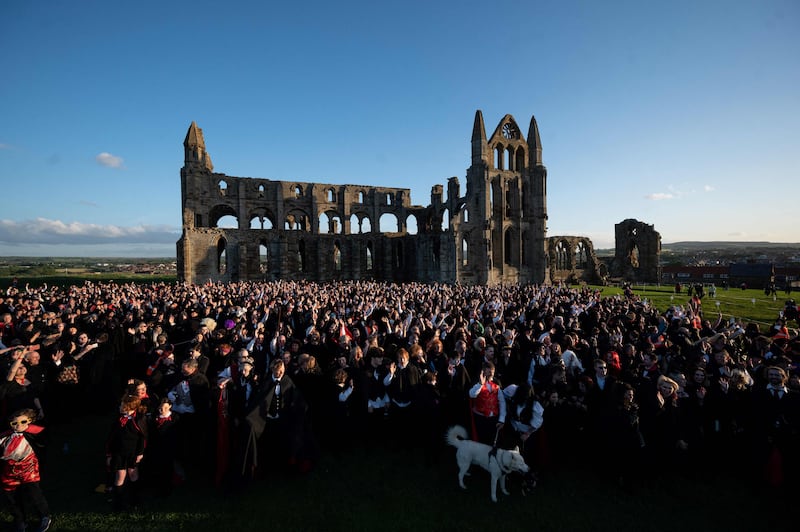 A crowd gathers in the grounds of Whitby Abbey, north-east England, during a Guinness world record attempt to gather the largest number of people dressed as vampires in one place. AFP