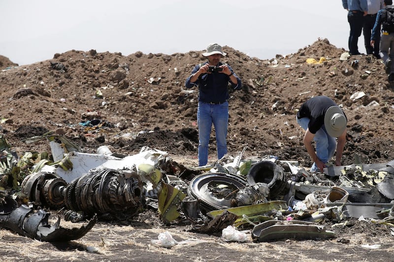 American civil aviation and Boeing investigators search through the debris. Reuters