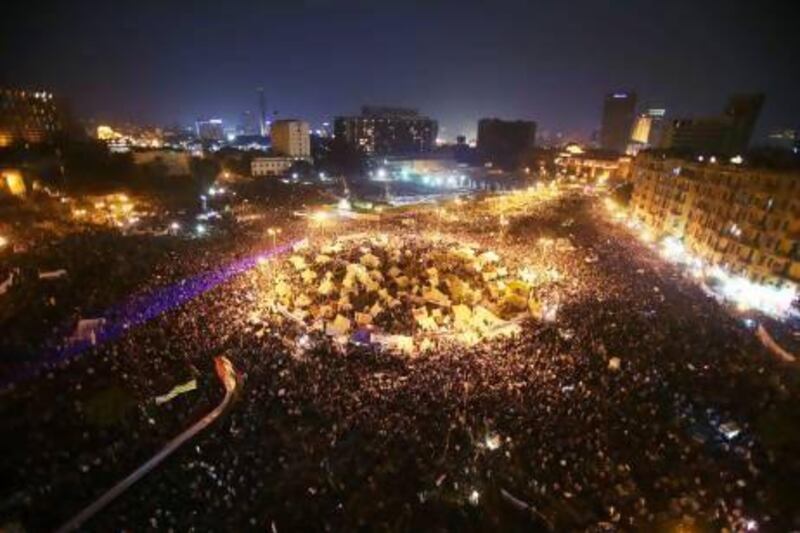 Protesters in Cairo converged in their thousands on Tahrir Square where a sit-in began last week after the president signed a decree making his decisions immune from legal challenge.