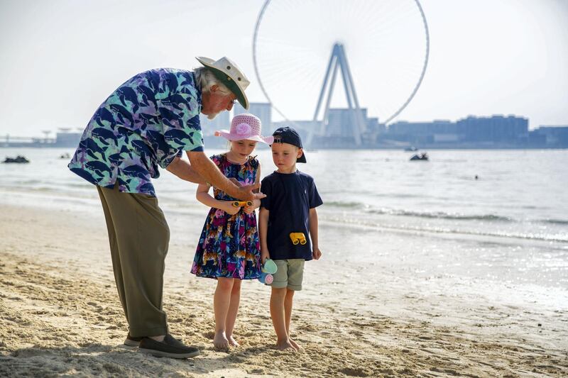 Jean-Michel Cousteau teaches children about the world's waters and the species that live within on a Dubai beach. Courtesy The Ritz-Carlton