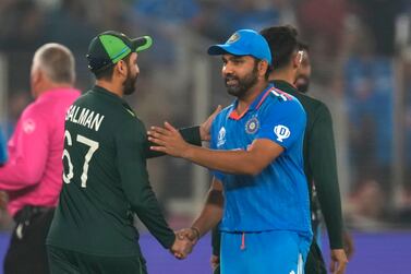 India's captain Rohit Sharma shakes hands with Pakistan's Pakistan's Salman Agha following India's win in the ICC Men's Cricket World Cup match between India and Pakistan in Ahmedabad, India, Saturday, Oct.  14, 2023. (AP Photo / Rajanish Kakade)