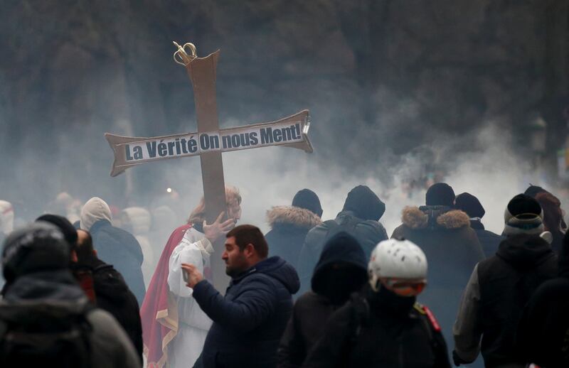 A protester carries a cross bearing the legend: 'Truth. We are being lied to'.  Reuters