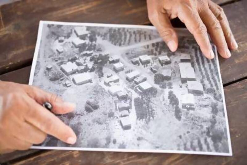 Shahdi Abu Al Qian shows an aerial view of the homes he had shared with his three wives and 32 children in Atir.