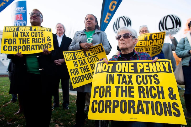 Demonstrators against the Republican tax reform bill hold a "People’s Filibuster to Stop Tax Cuts for Billionaires," protest rally outside the US Capitol on Capitol Hill in Washington, DC, November 30, 2017. / AFP PHOTO / SAUL LOEB