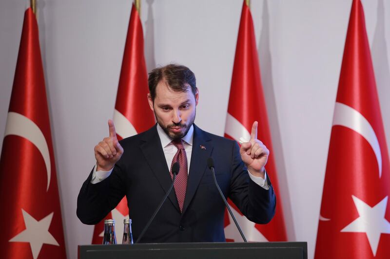 Berat Albayrak, Turkey's Treasury and Finance Minister, gestures as he talks during a conference in Istanbul, Friday, Aug. 10, 2018, in a bid to ease investor concerns about Turkey's economic policy. Albayrak said the government will safeguard the independence of the central bank and outlined his ministry's new economic policy as the currency plunged, raising questions about the country's financial stability. (AP Photo/Mucahid Yapici)
