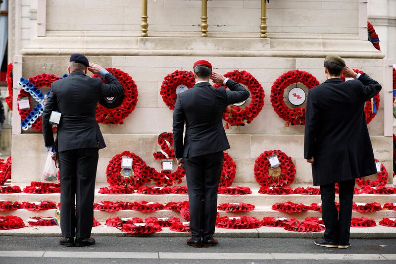 Men salute at the Cenotaph in Whitehall, London. Reuters