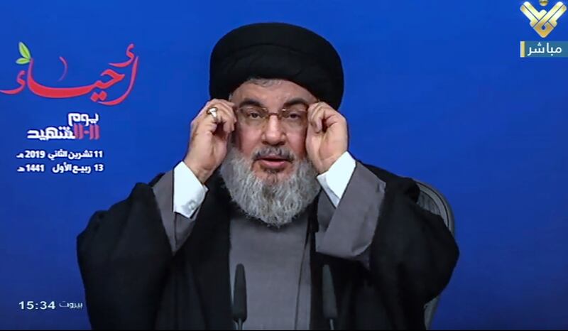 epa07988666 A handout grab photo made from Hezbollah's al-Manar TV shows Hezbollah leader Sayyed Hassan Nasrallah giving a speech during a ceremony to mark the party's Martyrs Day at Al Mahdi school in Al-Hadath, southern suburb of Beirut, Lebanon, 11 November 2019. Nasrallah addressed the political situation and the military conflicts in the Arab countries.  EPA/AL-MANAR TV GRAB HANDOUT  HANDOUT EDITORIAL USE ONLY/NO SALES