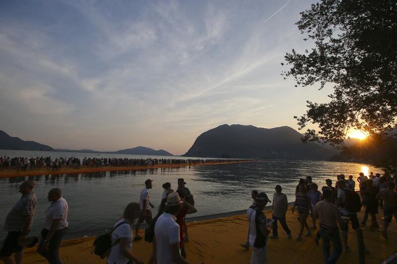 People enjoy the installation entitled ‘The Floating Piers’ at the Iseo Lake. Luca Bruno / AP photo