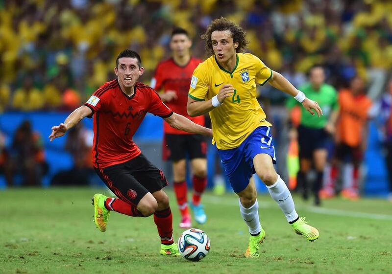 David Luiz of Brazil controls the ball against Hector Herrera of Mexico during their match at the 2014 World Cup on Tuesday in Fortaleza, Brazil. Buda Mendes / Getty Images