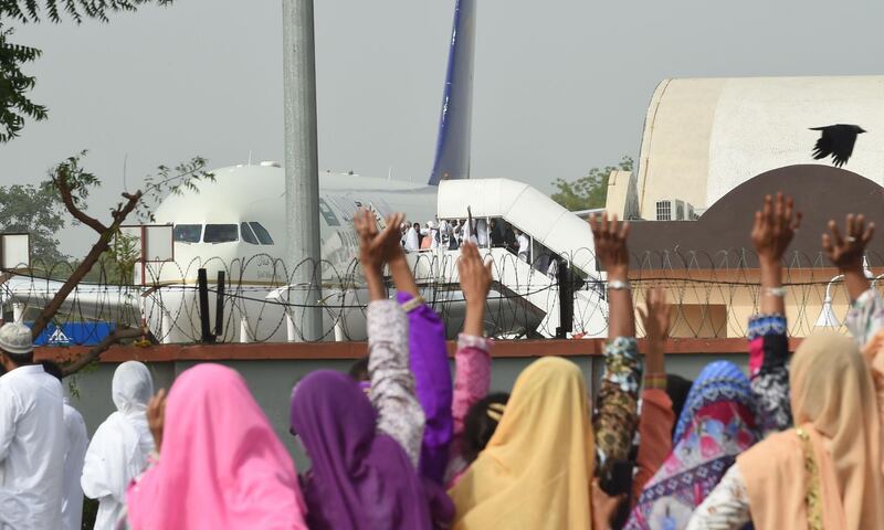 Indian relatives wave as Hajj pilgrims board an Airbus A330 flight bound for Saudi Arabia, at Sardar Vallabhbhai Patel International Airport in Ahmedabad on August 1, 2018. AFP