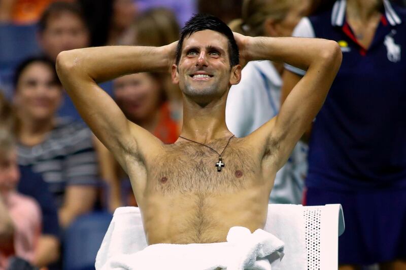 Djokovic cools off during a changeover. AFP