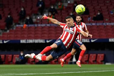 Atletico Madrid's Uruguayan forward Luis Suarez heads the ball during the Spanish league football match Club Atletico de Madrid against Real Sociedad at the Wanda Metropolitano stadium in Madrid on May 12, 2021. / AFP / PIERRE-PHILIPPE MARCOU