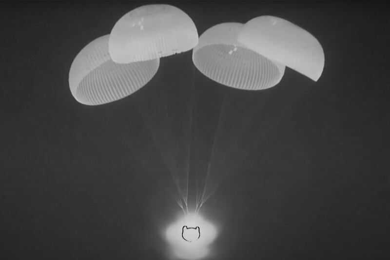 The SpaceX Dragon capsule's parachutes are deployed to slow its descent. Photo: Nasa