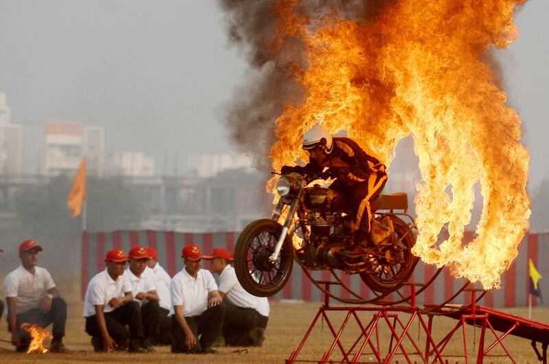 An member of India's 'Tornadoes' motorcycle display team ridesthrough  rings of fire during a display in Chennai. Arun Sankar / AFP Photo