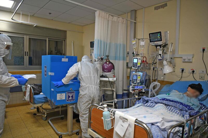 Israeli electoral workers dressed in full protective gear are pictured at a Covid-19 ward in Sheba Medical Centre in Ramat Gan. AFP