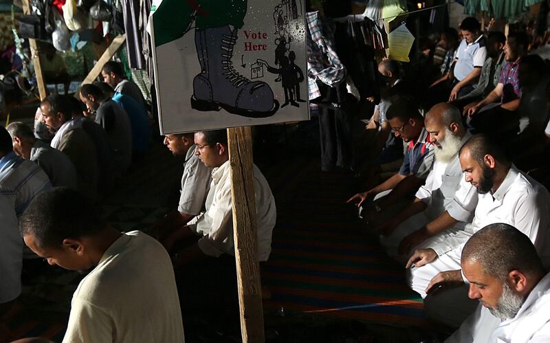 epa03805954 Muslim brotherhood supporters of ousted president Mohamed Morsi pray during a protest near Rabaa al-Adawiya mosque in Cairo, Egypt, 28 July 2013. Egyptian authorities on 26 July ordered ousted president Mohammed Morsi to be detained for 15 days pending further investigations on charges of conspiring to carry out 'hostile acts' in the country, reported state-run newspaper al-Ahram online. Morsi's backers and opponents were, meanwhile, rallying for rival demonstrations across the country, mainly in Cairo. Scores of anti-Islamist activists were turning out at central Cairo's Tahrir Square in response to a call made by army chief Abdel-Fattah al-Sissi, who engineered Morsi's ouster.The Islamist group's followers were also on 26 July flocking to the area of Rabaa al-Adawiya, in north-eastern Cairo, joining many others who have been camping there for weeks to protest what they call a military coup against Morsi, Egypt's first democratically elected president.  EPA/MOHAMMED SABER *** Local Caption ***  03805954.jpg