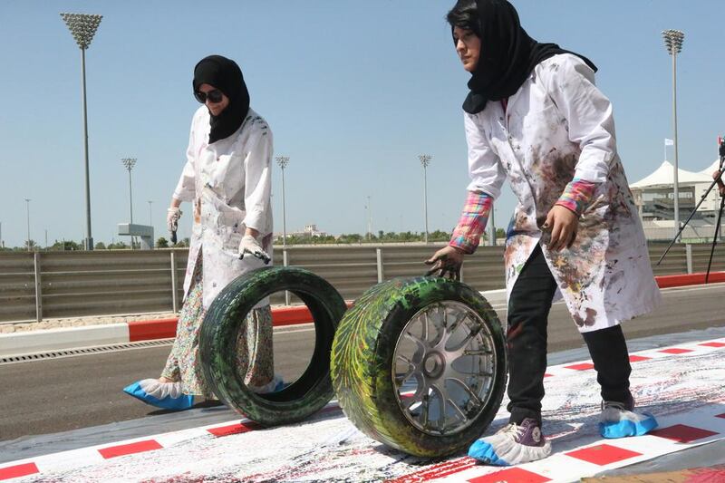 Fifty Zayed University students rolled tyres covered in paint along a 200-metre canvas in what could be deemed the world’s longest fine-art print. Fatima Al Marzooqi / The National