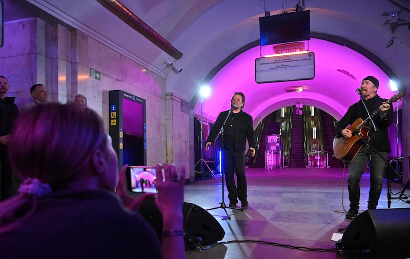 Irish singer and activist Bono, the lead vocalist of rock band U2, performs at a subway station that has been turned into a bomb shelter in Kyiv. AFP