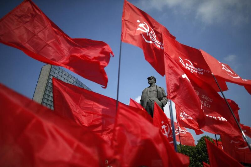 Participants wave communist flags near a statue of Soviet leader Vladimir Lenin during an International Worker's Day parade in Donetsk, east Ukraine. Marko Djurica / Reuters