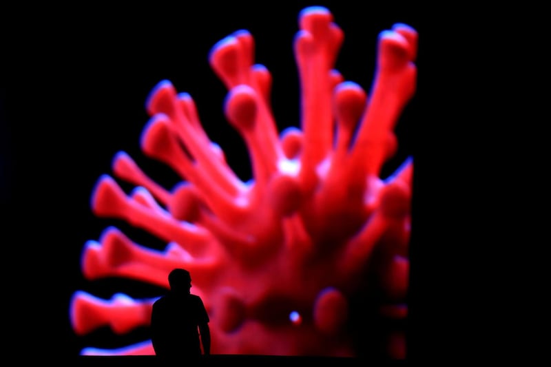 A man passes by an LED outdoor screen during the coronavirus outbreak in Brasilia, Brazil. Reuters