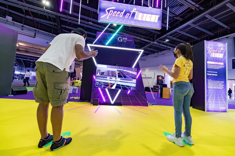 Dubai, United Arab Emirates - December 06, 2020:People play Speed of Light a Tron like game where people use their bodies as controllers during GITEX 2020 at the World Trade Centre. December 6th, 2020 in Dubai. Chris Whiteoak / The National