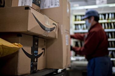 Amazon boxes sit at a United States Postal Service in the US. The company is reportedly in talks to buy driverless vehicle startup Zoox. Bloomberg