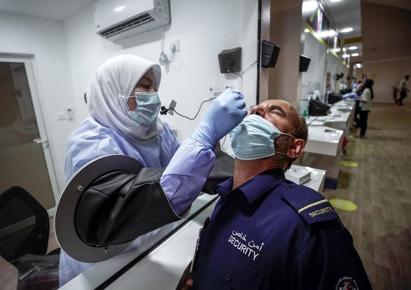 Abu Dhabi, United Arab Emirates, May 6, 2020. the new Ambulatory Healthcare Services, a SEHA Health System Facility, National Screening Project in Mussafah Industrial Area in Abu Dhabi.  --  A swab test is conducted on a security guard.Victor Besa / The NationalSection:  NAReporter:  Nick Webster