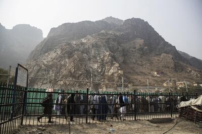 People stand in line to cross the border of Pakistan in Torkham, Nangarhar Province, Afghanistan, on Wednesday, Nov. 1, 2017. The Afghan economy is said to grow 2.6% in 2017 and revenue collection will rise due to the government's improved tax administration and better compliance, according to World Bank report. Photographer: Victor J. Blue/Bloomberg