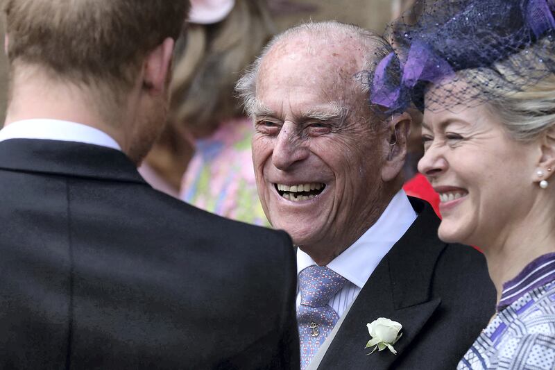 Britain's Prince Philip, Duke of Edinburgh reacts as he talks with Britain's Prince Harry, Duke of Sussex as they leave St George's Chapel in Windsor Castle, Windsor, west of London, on May 18, 2019, after the wedding of Lady Gabriella Windsor and Thomas Kingston. - Lady Gabriella, is the daughter of Prince and Princess Michael of Kent. Prince Michael, is the Queen Elizabeth II's cousin. (Photo by Steve Parsons / POOL / AFP)