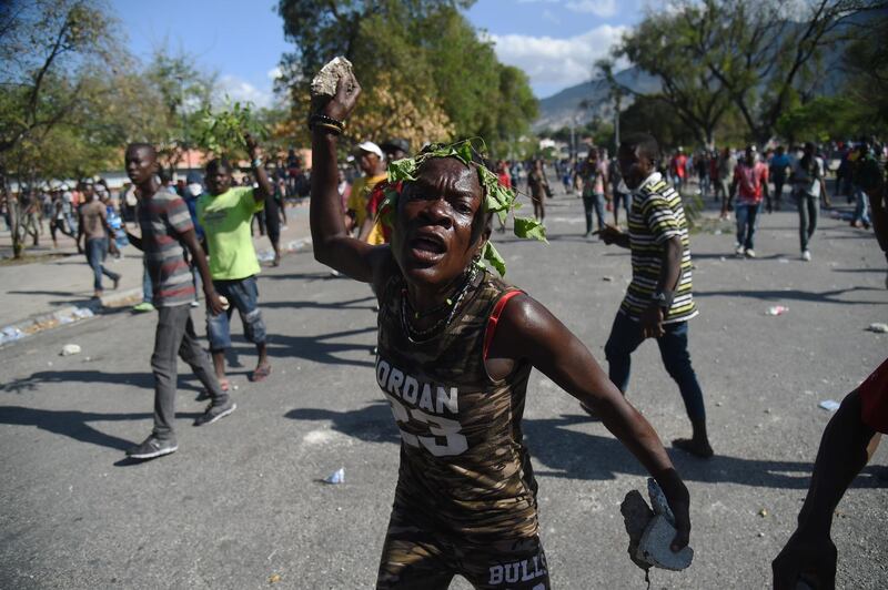 A demonstrator gestures during clashes in front of the National Palace, in the centre of Haitian Capital Port-au-Prince. AFP