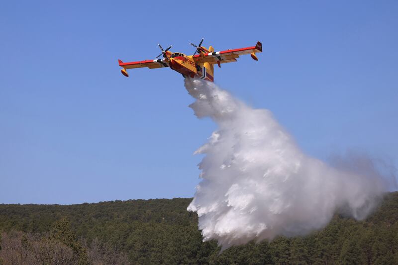 A plane drops water to combat the Hermits Peak and Calf Canyon wildfires near Las Vegas, New Mexico. Reuters