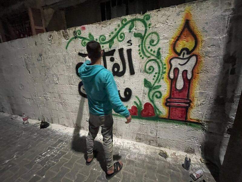 Calligrapher Abdullah Herz, 24, creating congratulatory artwork in Gaza City