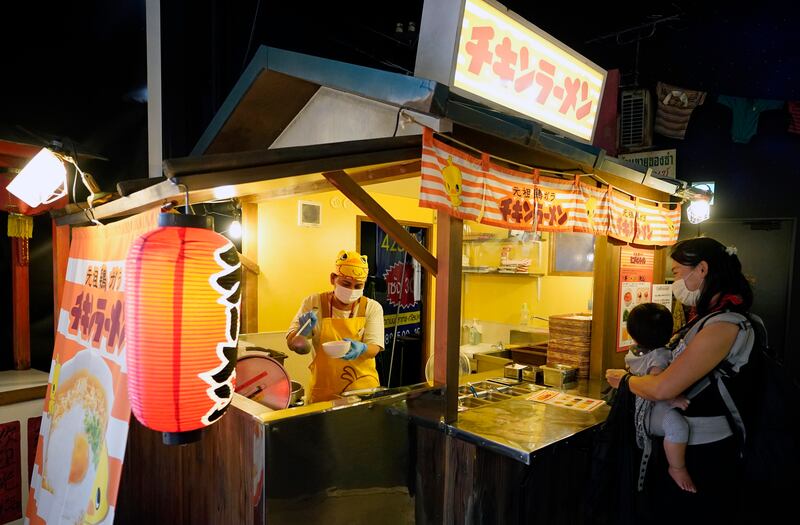 A woman prepares instant noodles at the Noodles Bazaar. EPA