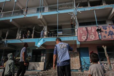 Palestinians and UN officials inspect the damage to a school complex for displaced Palestinians, run by UNRWA. Bloomberg
