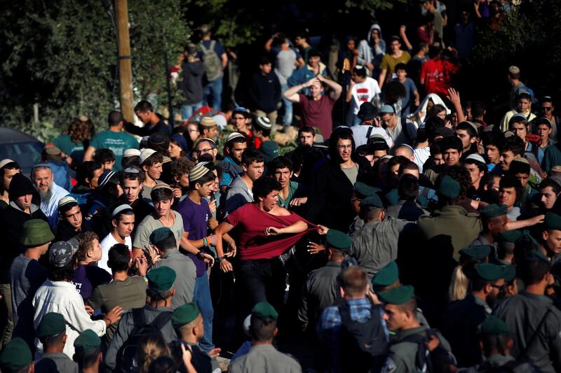 Israeli security forces scuffle with protestors as they come to evacuate 15 Jewish settler families from the illegal outpost of Netiv Haavot in the Israeli occupied West Ban. Ronen Zvulun / Reuters