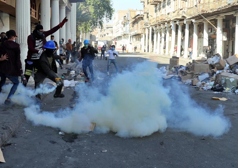 Riot police fire tear gas while blocking Rasheed Street. AP Photo