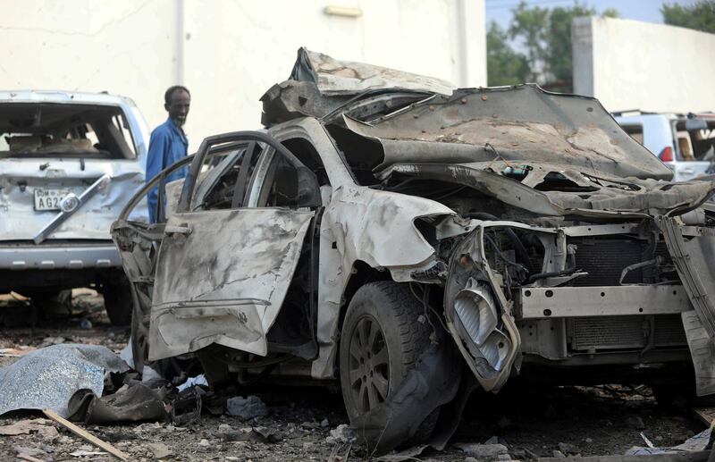 A security officer from Doorbin Hotel assesses the debris after a suicide car explosion in front of the hotel in Mogadishu, Somalia. Feisal Omar / Reuters