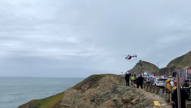 Emergency personnel respond after a Tesla plunged off a cliff along the Pacific Coast Highway in Northern California. AP