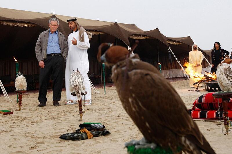 US president George W Bush talks with Sheikh Mohammed bin Zayed at a desert camp in January 2008, as Sheikh Mohammed bin Rashid and US secretary of state Condoleezza Rice stand by.

Philip Cheung / The National