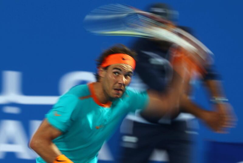 Spanish tennis player Rafael Nadal returns the ball to Stanislas Wawrinka of Switzerland during their 3rd/4th place tennis match in the Mubadala World Tennis Championship in Abu Dhabi on January 3, 2015. AFP PHOTO/MARWAN NAAMANI (Photo by MARWAN NAAMANI / AFP)