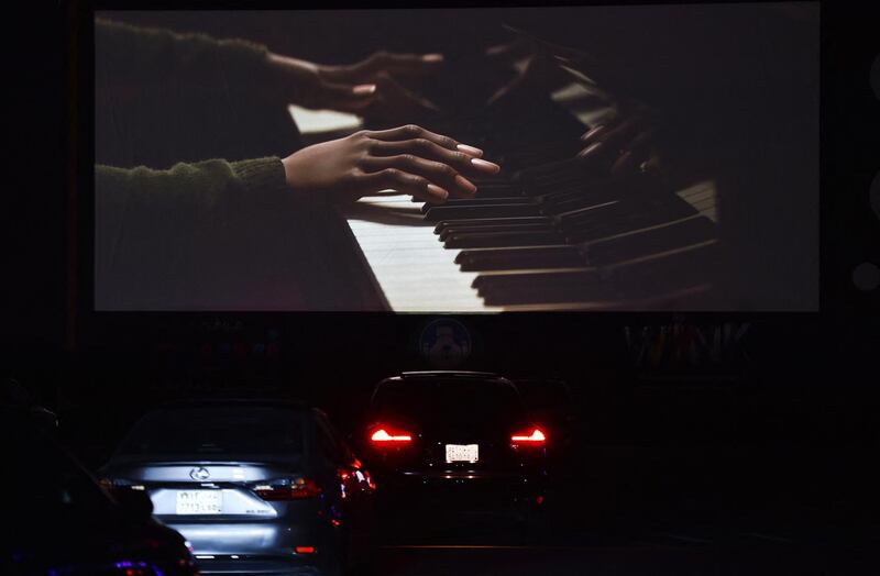 Vehicles take their place in the first drive-in cinema in the Saudi capital Riyadh which can accommodate up to 150 vehicles while maintaining social distancing measures amidst the Covid-19 pandemic, on January 26, 2021. (Photo by FAYEZ NURELDINE / AFP)