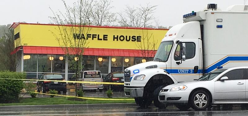 Police vehicles sit outside a Waffle House restaurant in Nashville, Tenn., Sunday, April 22, 2018. A man stormed the Waffle House restaurant in Tennessee before dawn Sunday and shot several people to death, according to police, who credited a customer with saving lives by wresting a weapon away from the gunman. (AP Photo/Sheila Burke)