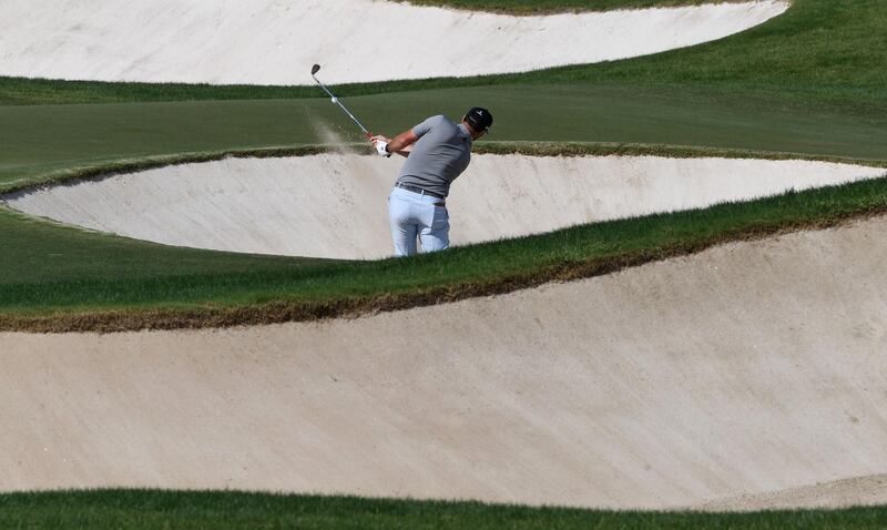 Jon Rahm of Spain takes a shot from a bunker at the DP World Tour Championship. AFP