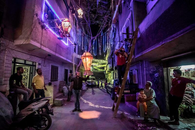 Egyptian youths decorate their residential street in preparation for Ramadan in Cairo's Hadayek El Maadi district. AFP