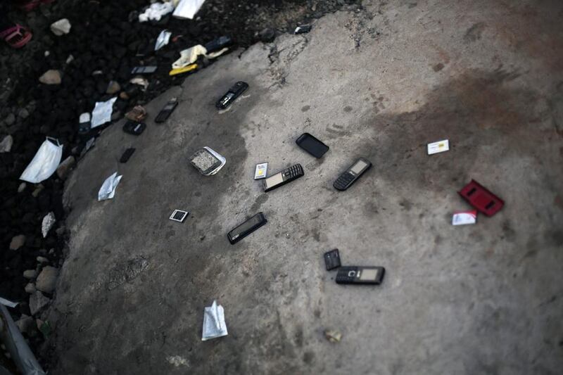 Cellphones are thrown on the ground by patients leaving the treatment unit with a clean bill of health — they discard their phones in fear that they might contain the Ebola virus. 