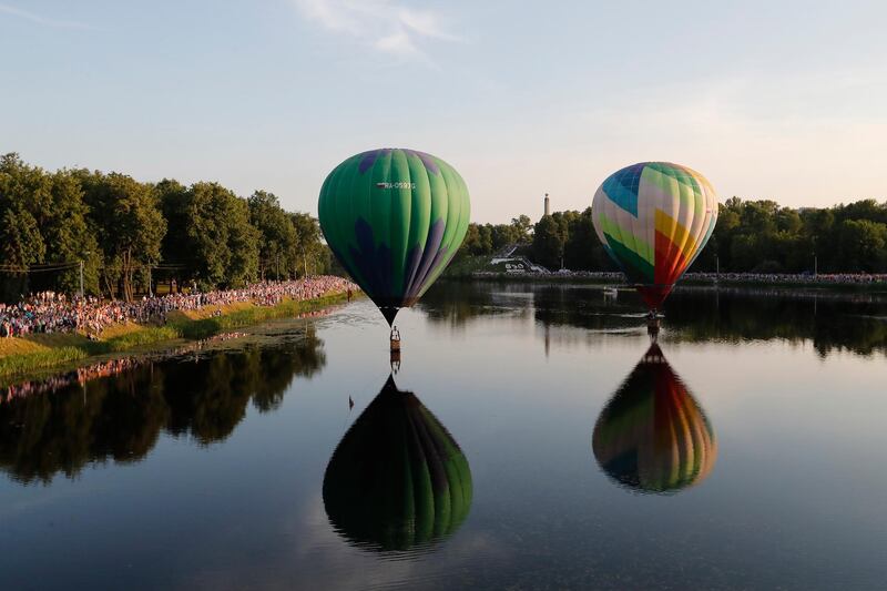 Hot air balloons fly over Lovat River during the 24th International Balloon Meet in Velikie Luki, Pskov region, Russia.  EPA